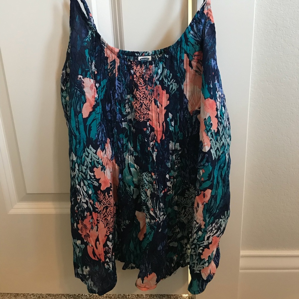 Old navy tank with coral beach scene